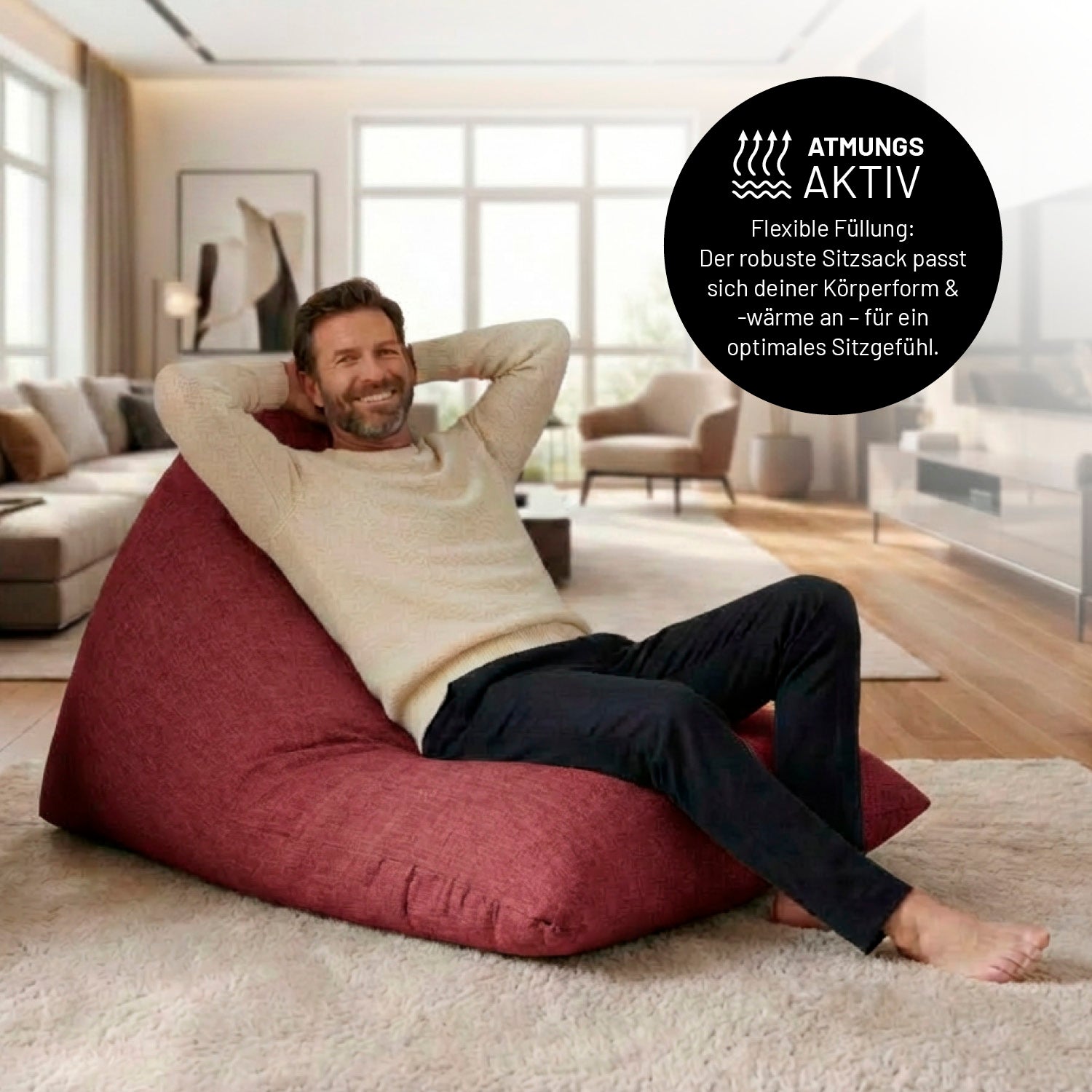 Mann entspannt auf Sitzsack Interior Line (370 L) - indoor - Rot in modernem Wohnzimmer mit hochwertiger Leinenoptik.