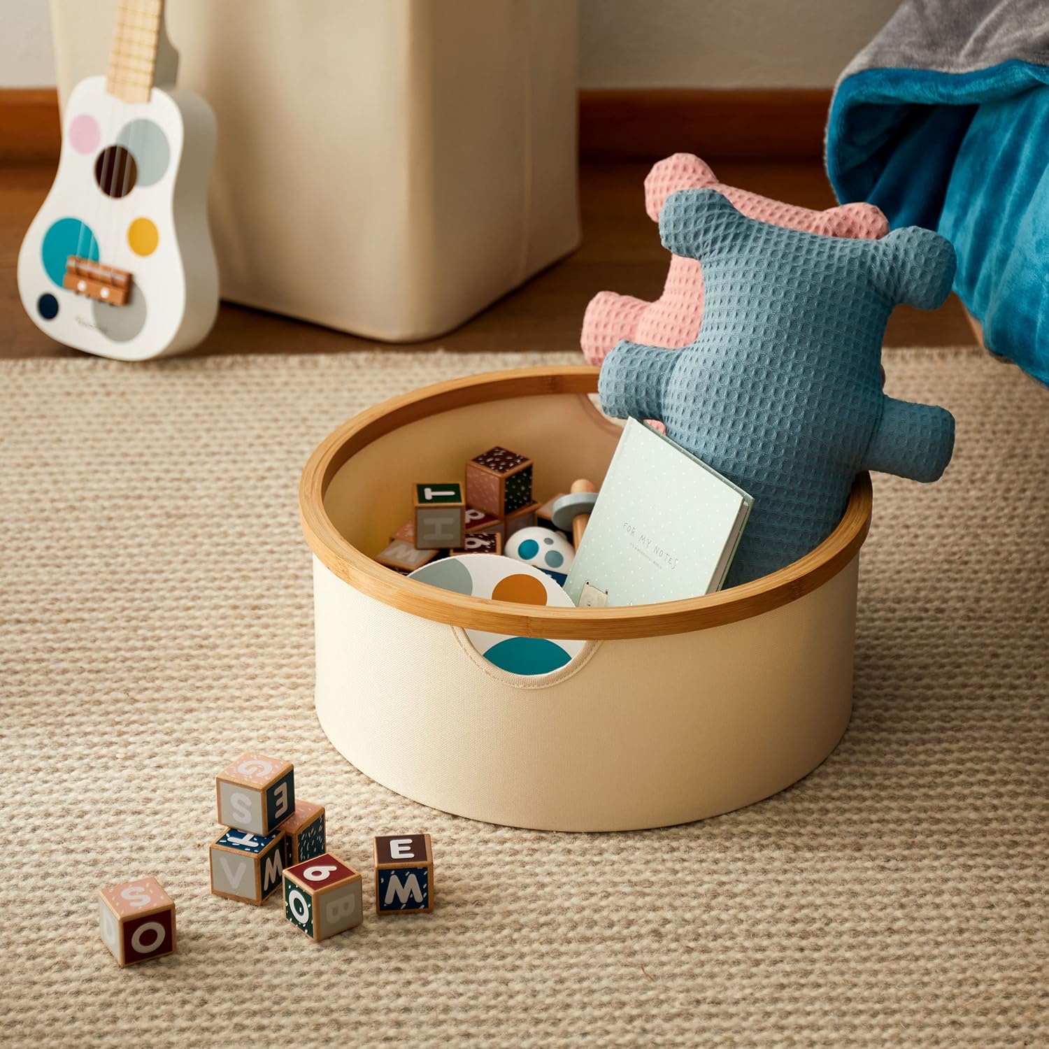 Bambus-Rahmen Aufbewahrungsbox rund - 3er-Set - Grau/Anthrazit mit Spielzeug und Buch auf Teppichboden.