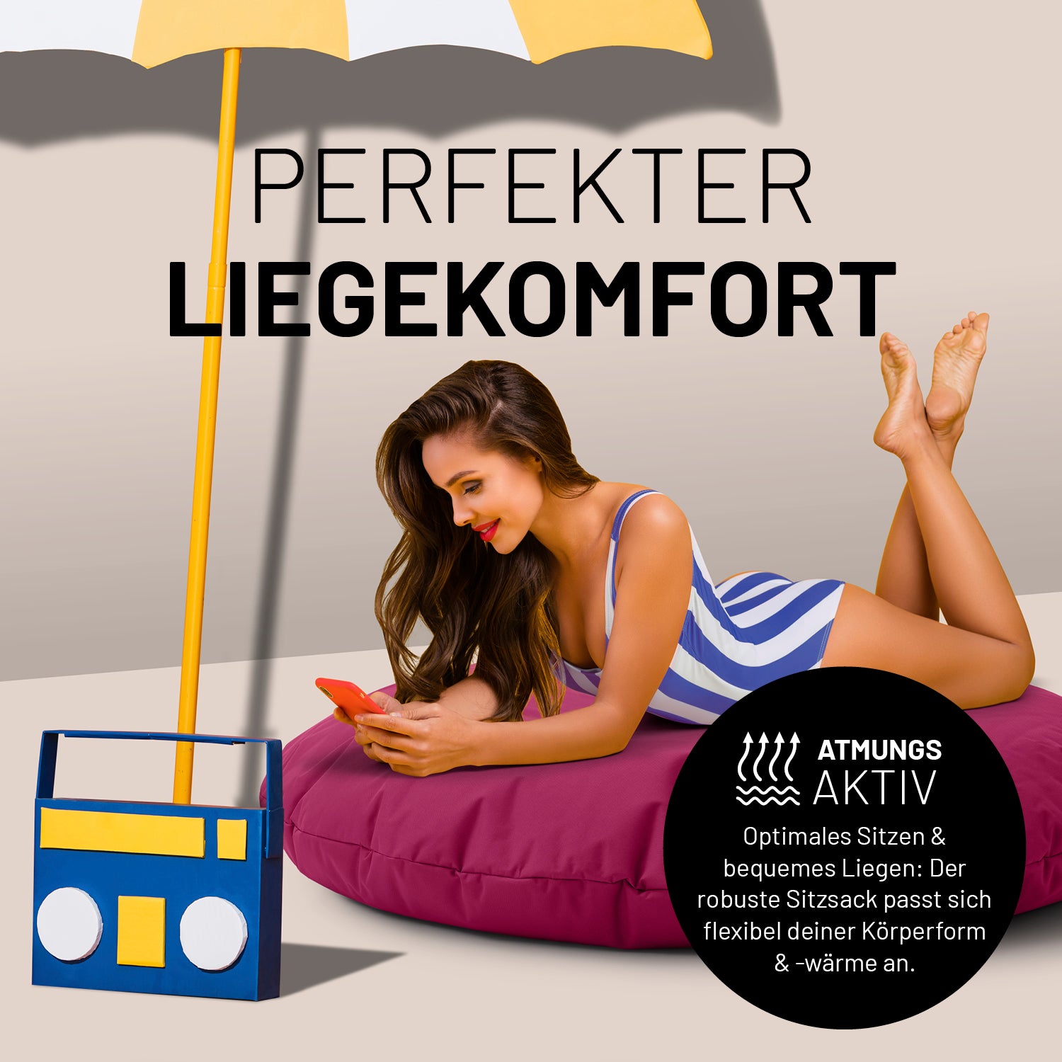 Frau liegt entspannt auf Sitzsack Drops (300 L) - indoor & outdoor - Weinrot, umgeben von Sonnenschirm und Boombox.